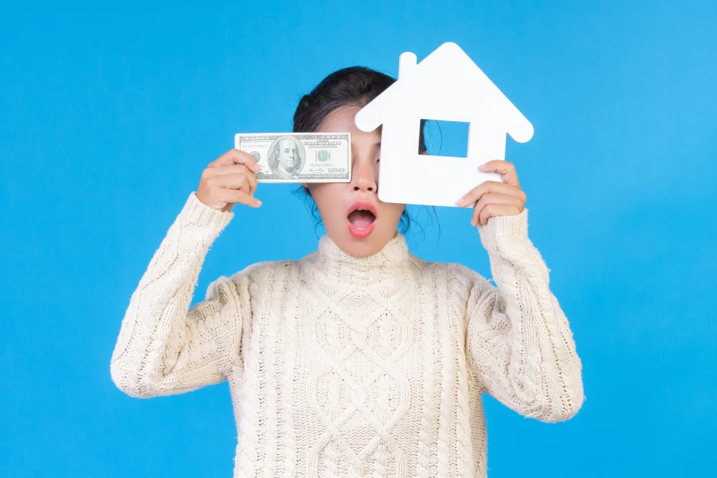 beautiful-woman-wearing-new-long-sleeved-white-carpet-that-holds-house-symbol-dollar-bills-blue-trad | Homesell